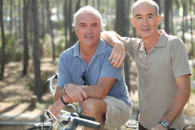 Portrait of two friends on bikes clipart