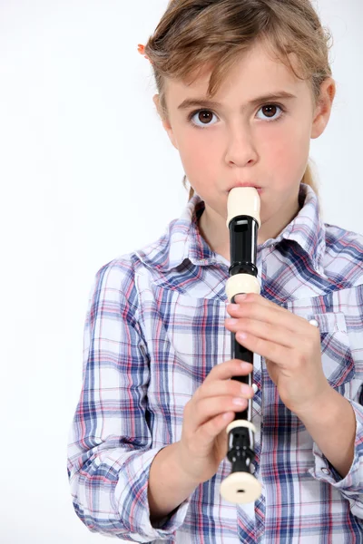 Little girl playing a recorder — Stock Photo, Image