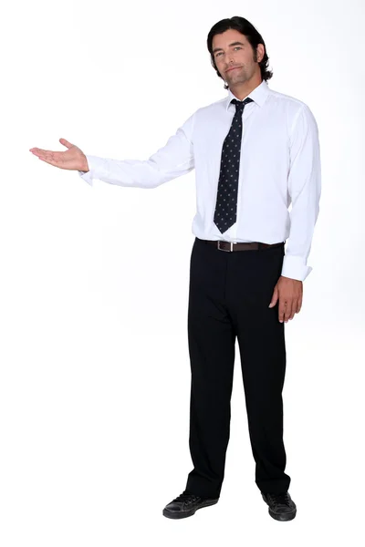 Businessman holding his hand out into open space — Stock Photo, Image