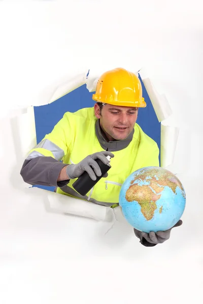 Construction worker with spray and globe — Stock Photo, Image