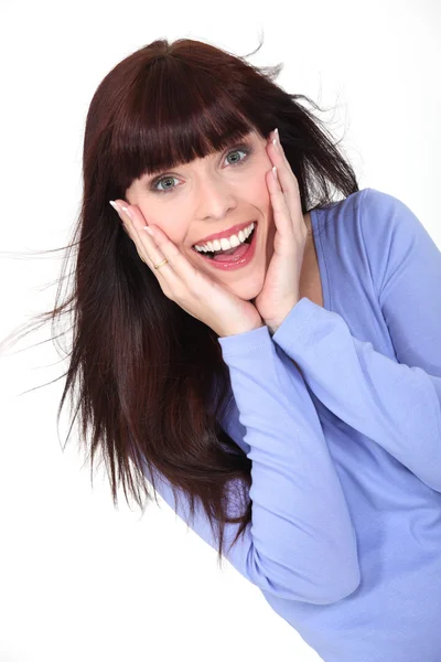 Delighted woman with her hands to her face — Stock Photo, Image