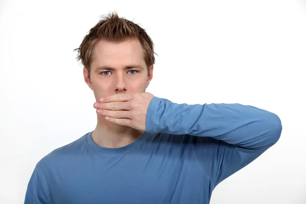 Man with hand on mouth — Stock Photo, Image