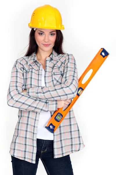 Pretty female carpenter posing with ruler — Stock Photo, Image