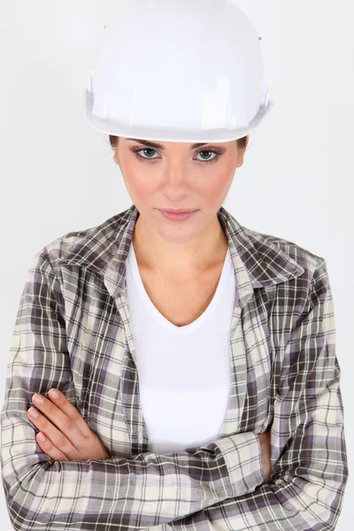 A female construction worker with their arms crossed. — Stock Photo, Image