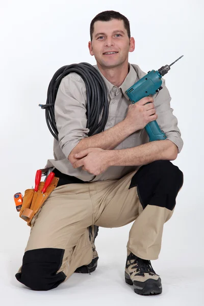 Woodworker crouching on white background — Stock Photo, Image