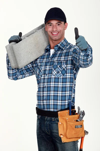 Builder carrying building block — Stock Photo, Image