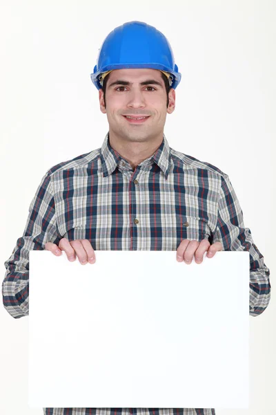 Craftsman holding a blank poster — Stock Photo, Image