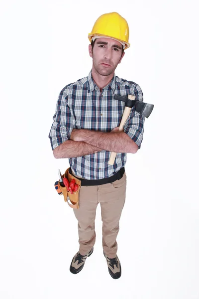 Grumpy tradesman holding a hatchet — Stock Photo, Image