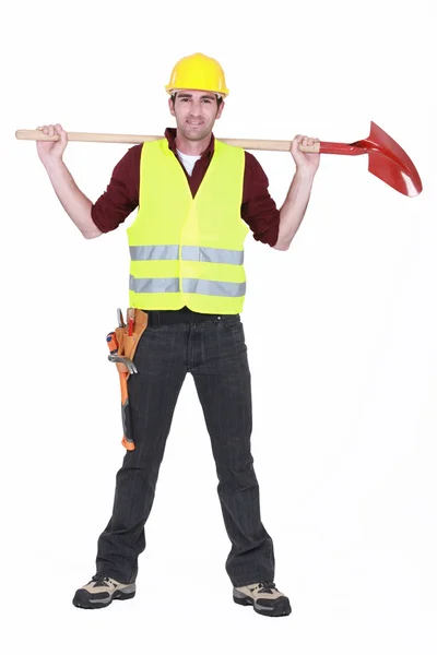 Full-body portrait of bricklayer standing legs apart carrying shovel on his — Stock Photo, Image
