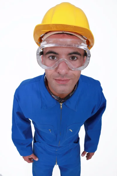 Craftsman in overalls wearing protection glasses — Stock Photo, Image