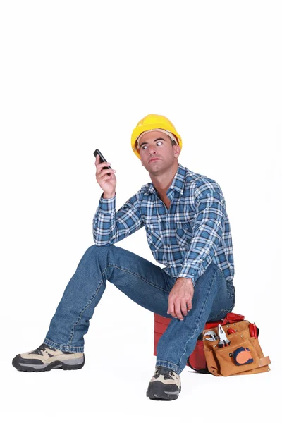 Tradesman fed up with his ringing phone — Stock Photo, Image