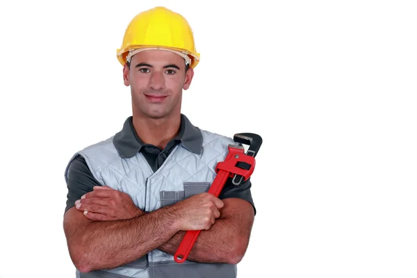 Portrait of tradesman cross-armed holding adjustable spanner — Stock Photo, Image