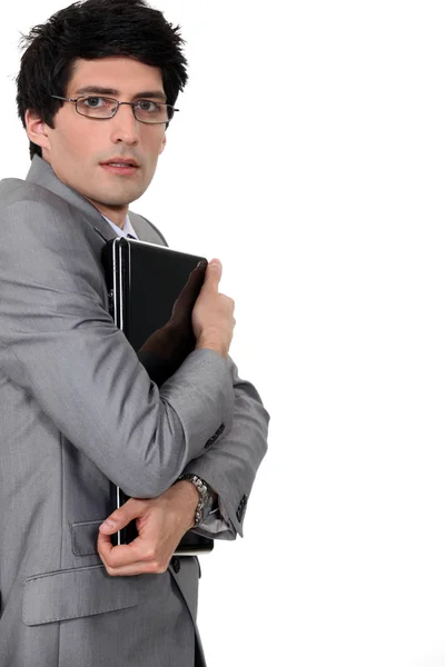 Biznesmen ściskając jego laptop — Zdjęcie stockowe