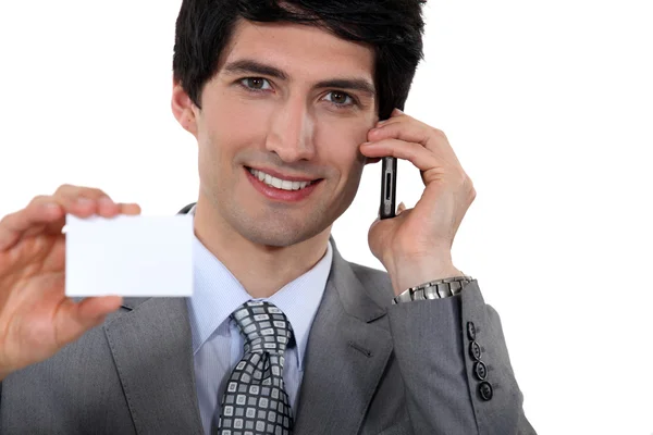 Executive holding a blank business card — Stock Photo, Image