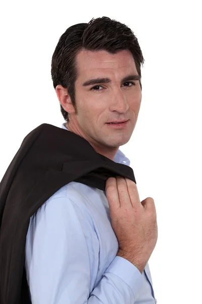 Portrait of a tired businessman carrying his blazer — Stockfoto