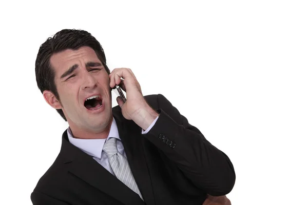 Businessman screaming down the phone — Stock Photo, Image
