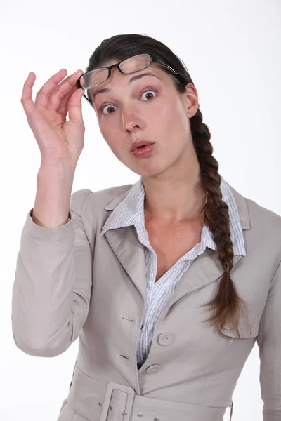 Surprised woman taking off her glasses — Stock Photo, Image