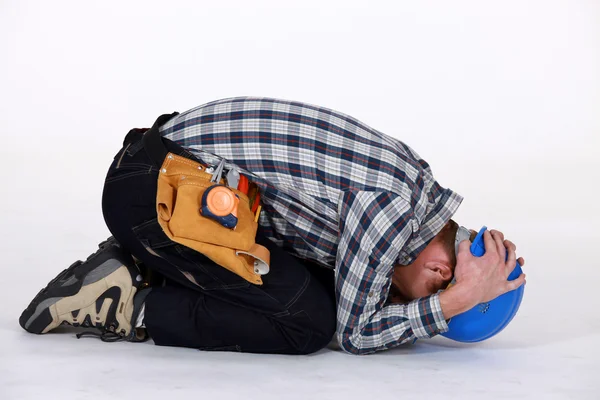 Construction worker curled up — Stock Photo, Image