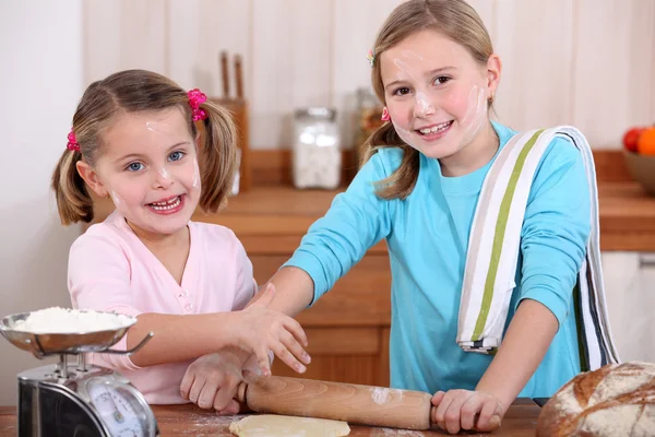 Young girls using a rolling pin — Stock Photo, Image