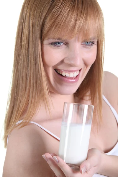 Happy woman holding glass of milk — Stock Photo, Image
