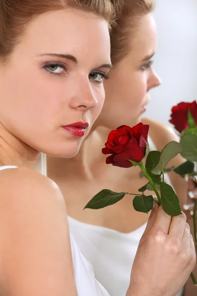 Woman holding single rose — Stock Photo, Image