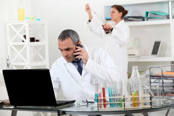 A pair of scientists conducting an experiment Stock Photo