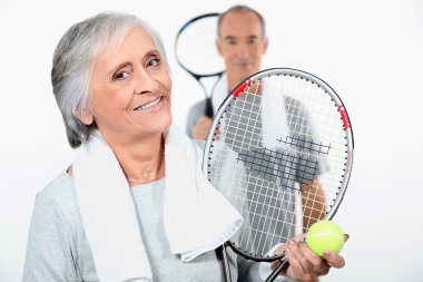 Elderly couple playing tennis clipart