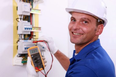 Electrician checking a fuse box clipart