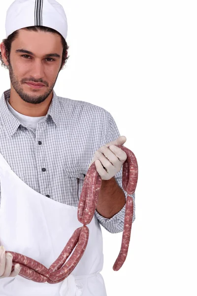 Butcher with sausages — Stock Photo, Image