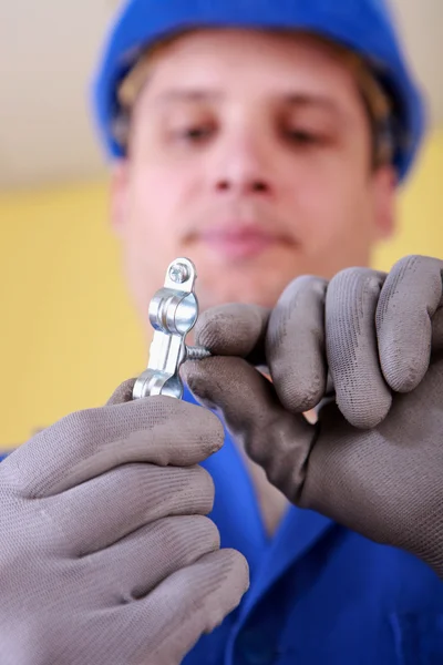 Craftsman holding a screw — Stock Photo, Image