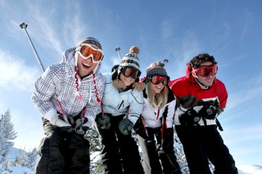 Group of teenagers skiing clipart