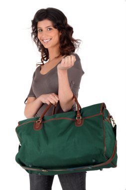 Young woman smiling with travel bag clipart