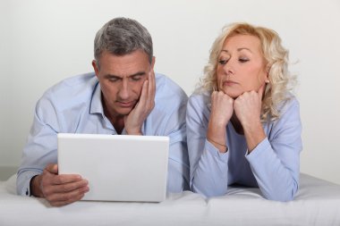 Older couple with a laptop clipart