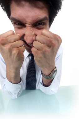 Frustrated businessman clenching his fists clipart