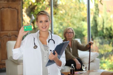 A nurse visiting an elderly patient at home clipart