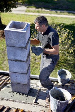 Mason building chimney clipart