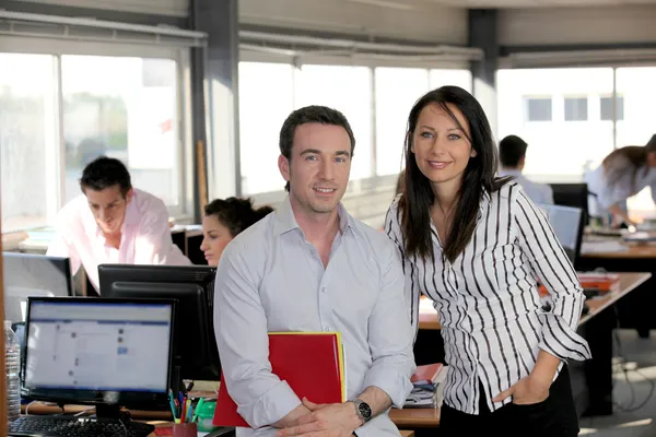 Business partners in a busy office — Stock Photo, Image