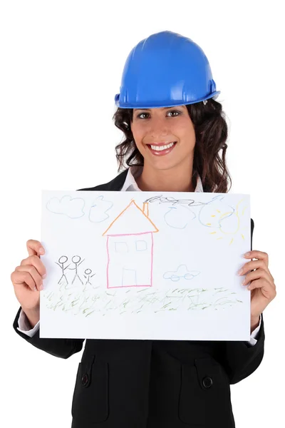 Architect holding a child's drawing of a house — Stock Photo, Image