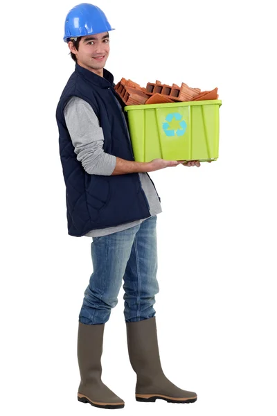 Young tradesman taking out the recycling — Stock Photo, Image