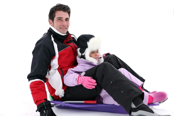 Father and daughter on a sledge — Stock Photo, Image