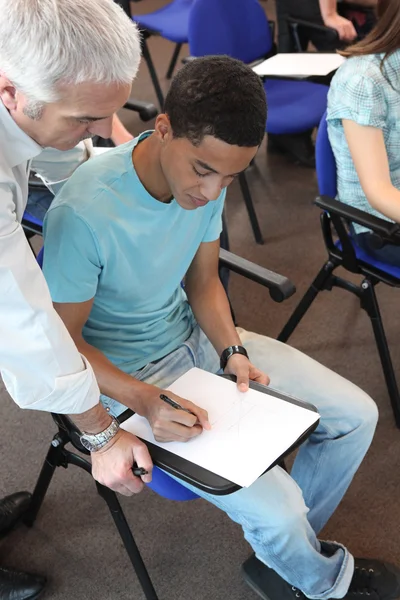 Young man in professional training with teacher — Stock Photo, Image