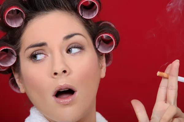 stock image Woman with hair curlers smoking a cigarette