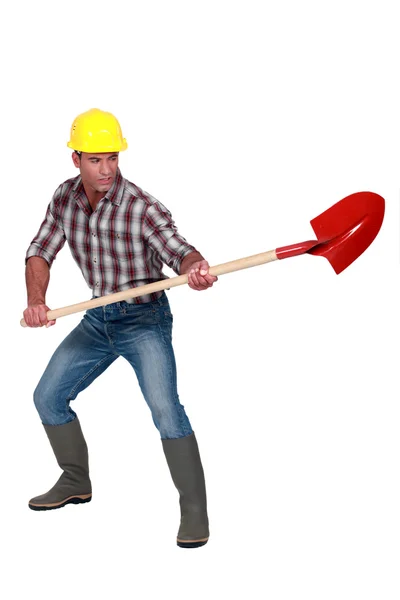 Hantverkare innehar en spade — Stockfoto