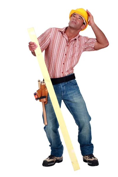 Tradesman trying to protect himself from falling debris — Stock Photo, Image
