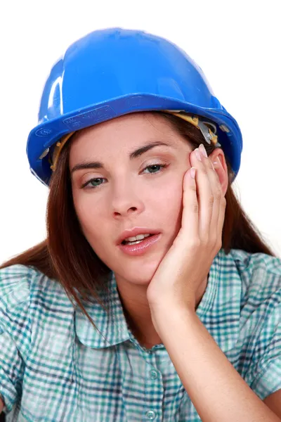 A tired-looking tradeswoman — Stock Photo, Image