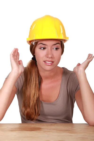 Young woman expressive sitting at a desk — Stock Photo, Image