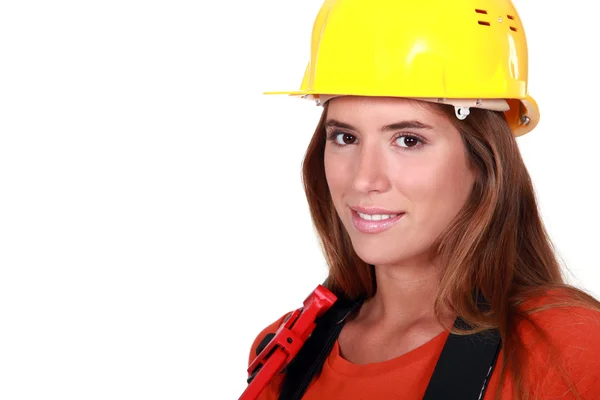 Attractive female worker holding wrench — Stock Photo, Image