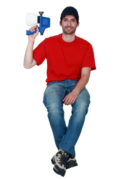 Young craftsman holding a sprayer — Stock Photo, Image