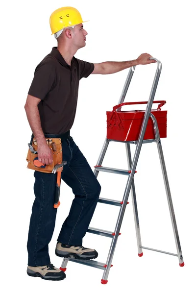 Homem com uma caixa de ferramentas e escada rolante — Fotografia de Stock