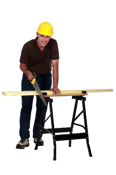 A carpenter with a handsaw. — Stock Photo, Image